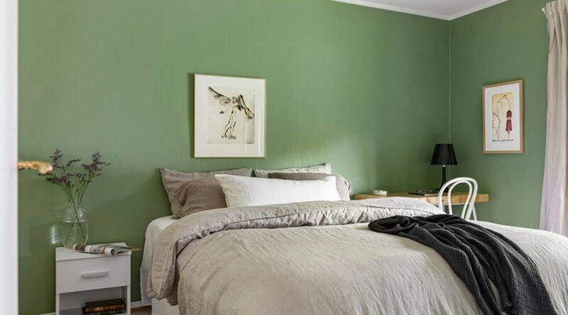 Green bedroom ideas: a calm bedroom with soft sage green walls and crisp white bedding
