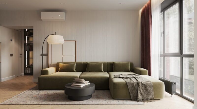 Sage green living room with a large green sofa and soft natural light