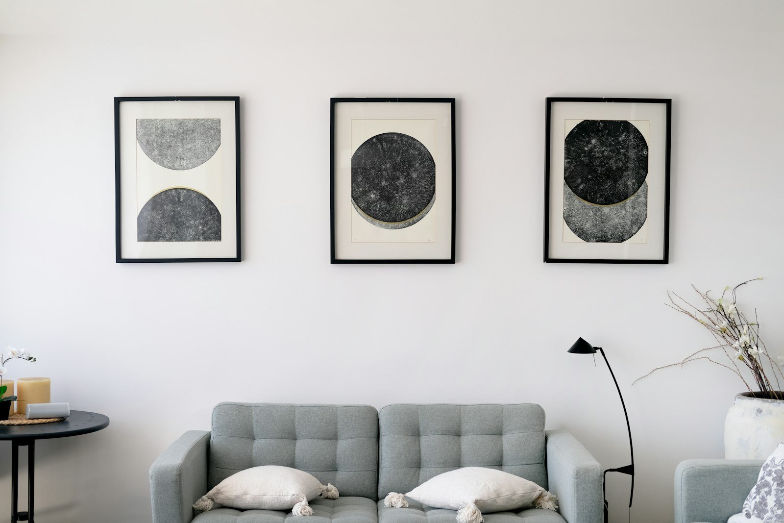 Framed art gallery wall hung above a sofa as a renter friendly apartment decor idea