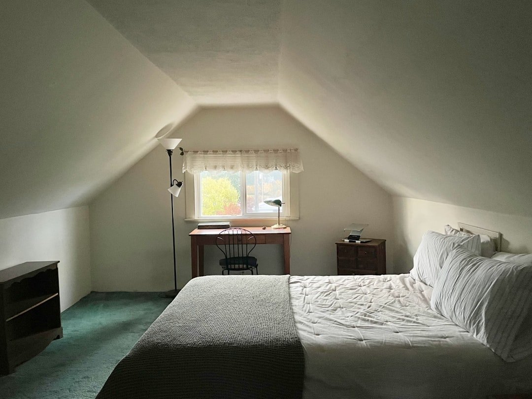 Small attic bedroom with a sloped ceiling painted one color, a small bedroom idea for awkward rooms and rentals