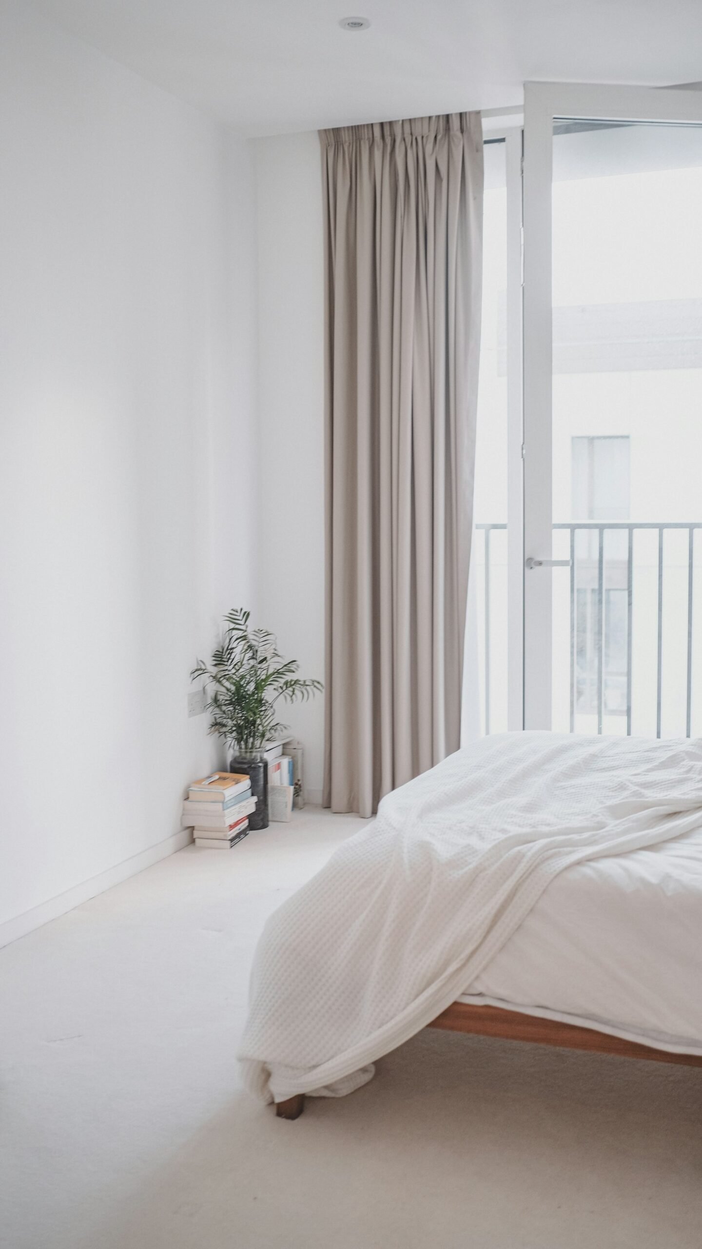 Full length curtains at a bedroom window, a cozy bedroom window idea