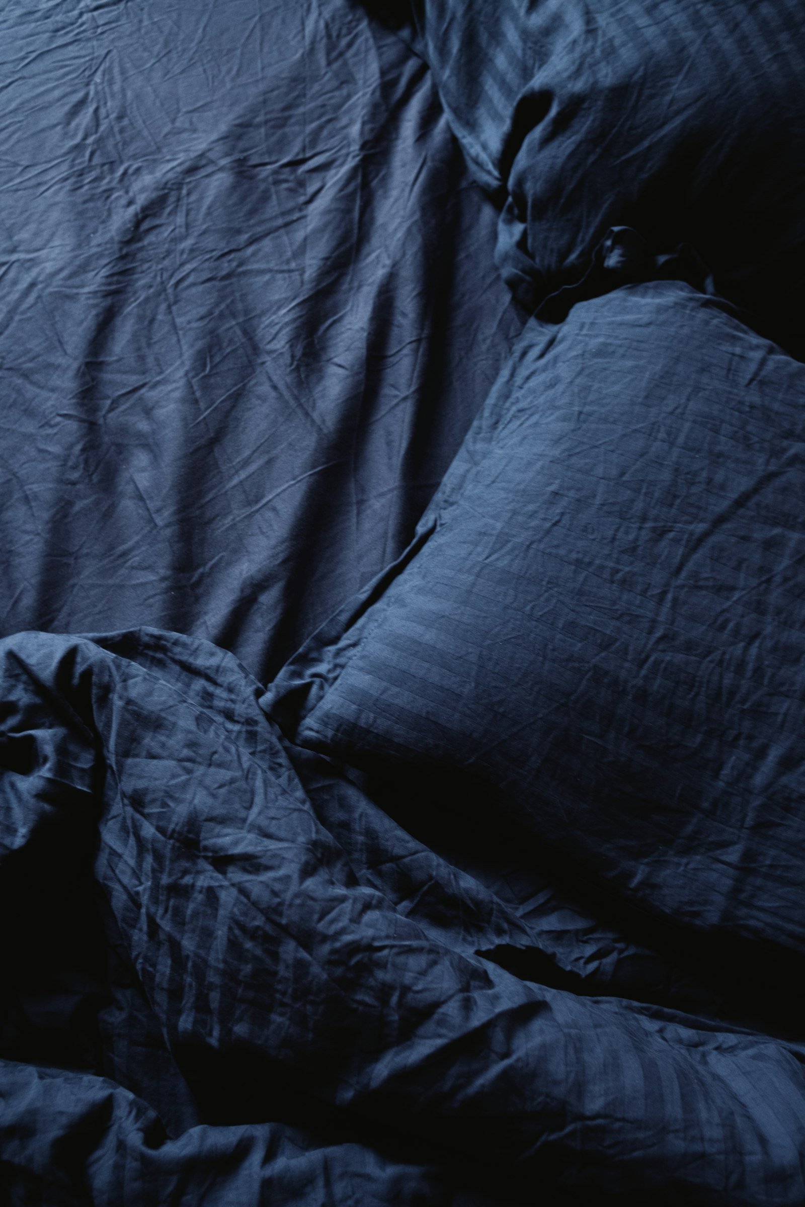 No paint blue bedroom idea using blue bedding and pillows on a white bed