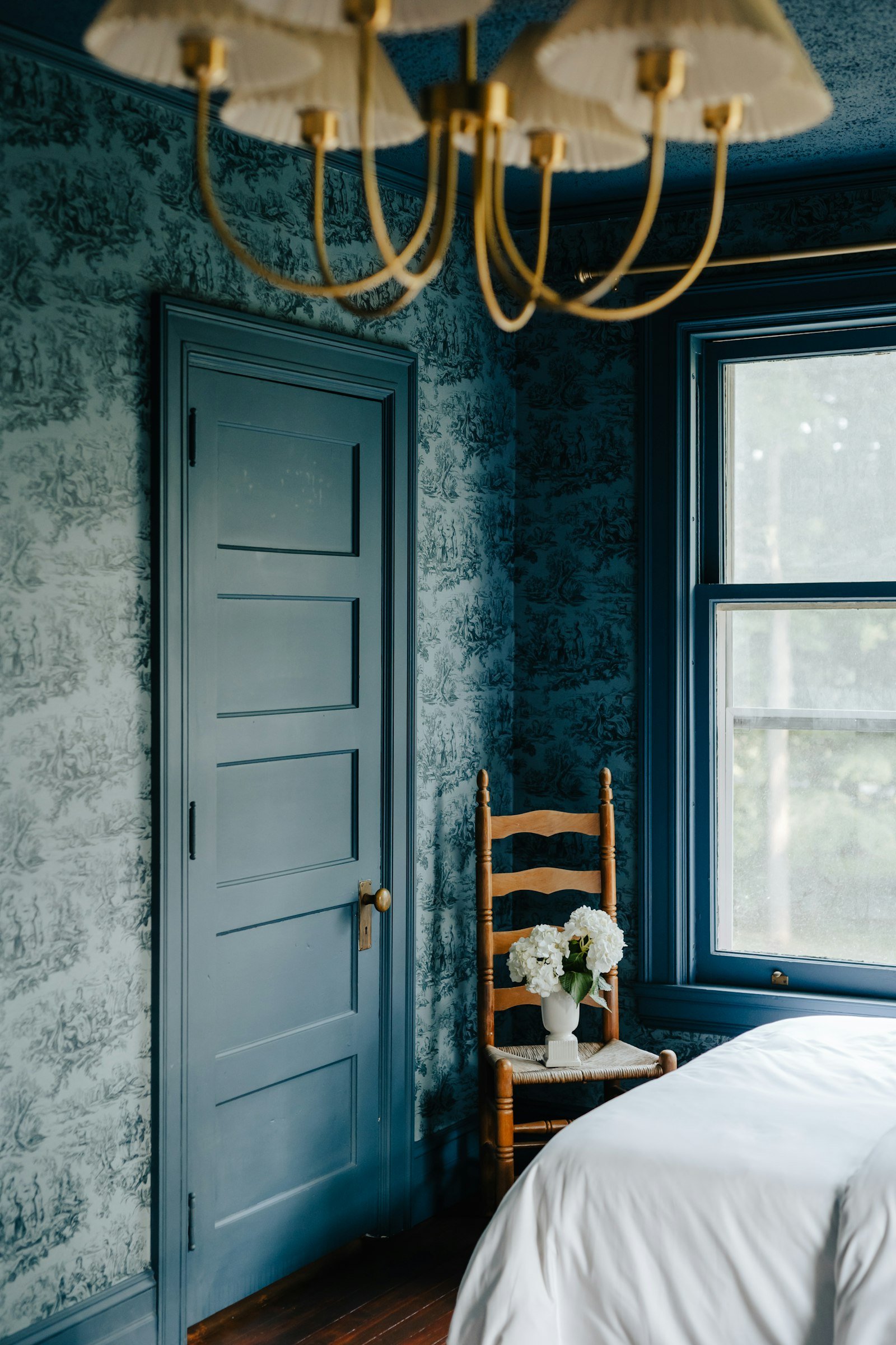 Blue gray bedroom idea with muted slate walls and simple bedding
