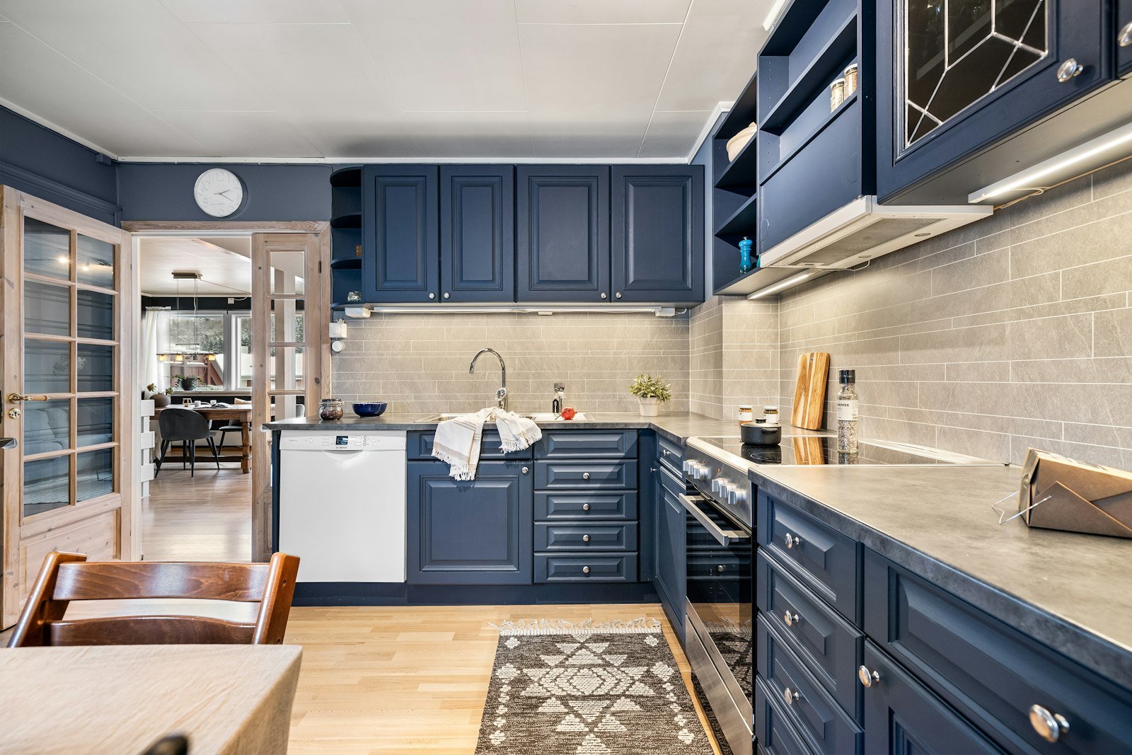Blue kitchen cabinet ideas with white walls and light countertops