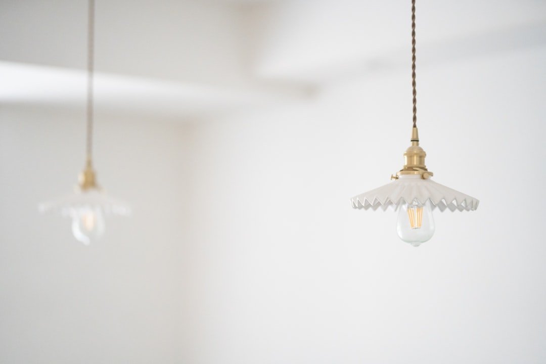 Brass and clear glass pendant light with a warm bulb hanging over a kitchen counter