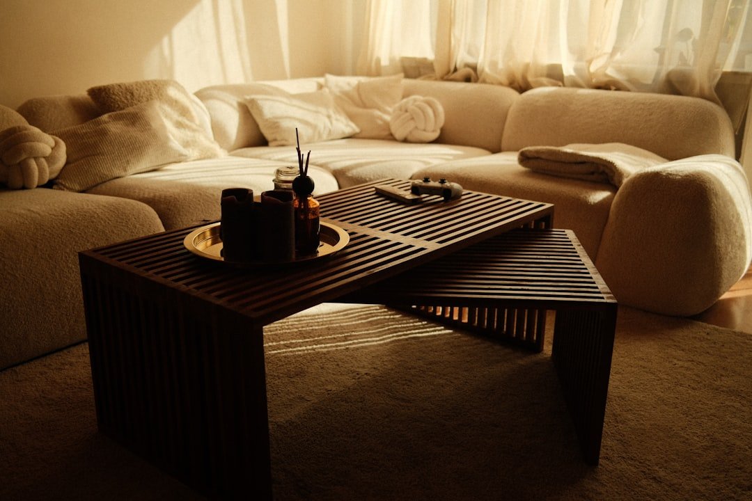 Cozy brown living room with sculptural sofa, wood coffee table, and warm lighting