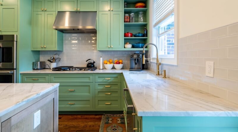 Colorful kitchen ideas: green painted cabinets with marble counters and warm white walls