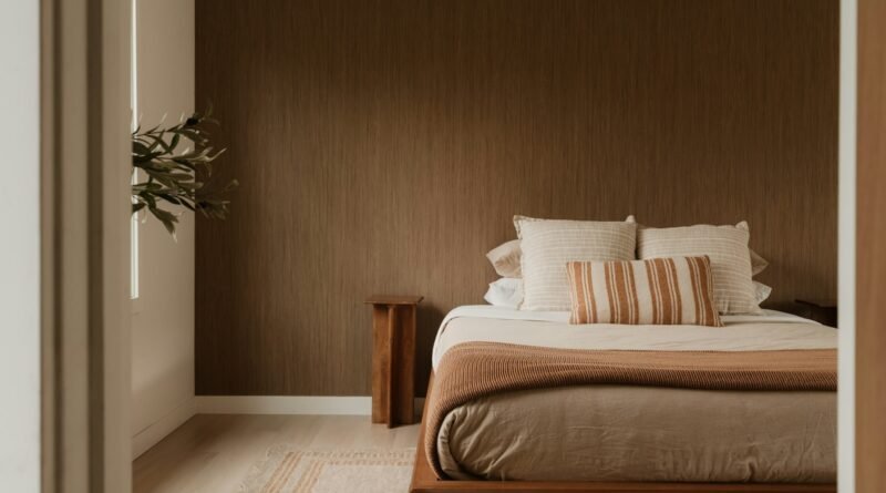 Cozy bedroom ideas: a warm layered bedroom with soft bedding and low lamp light