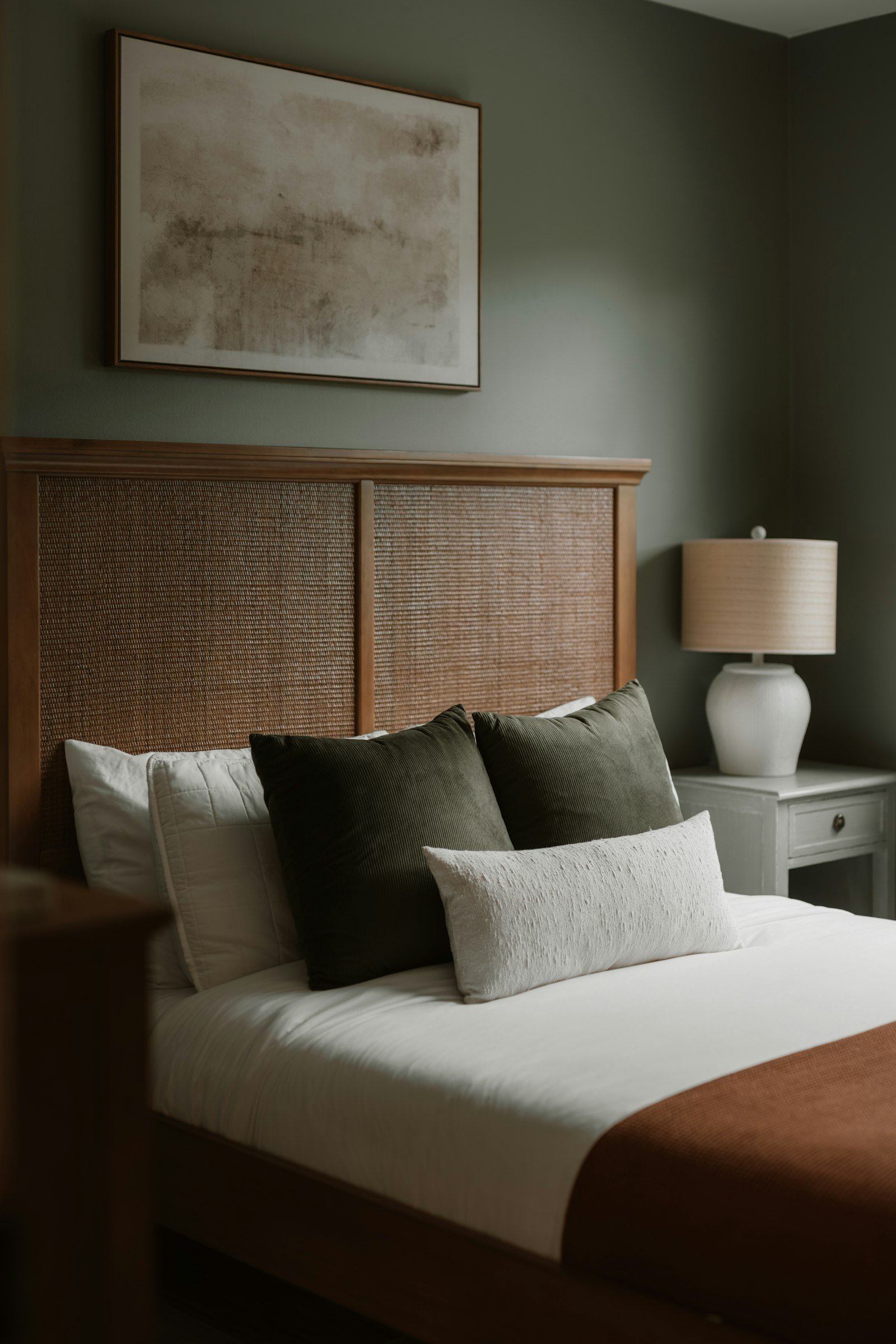 Cozy bedroom ideas with warm painted walls and a soft made bed