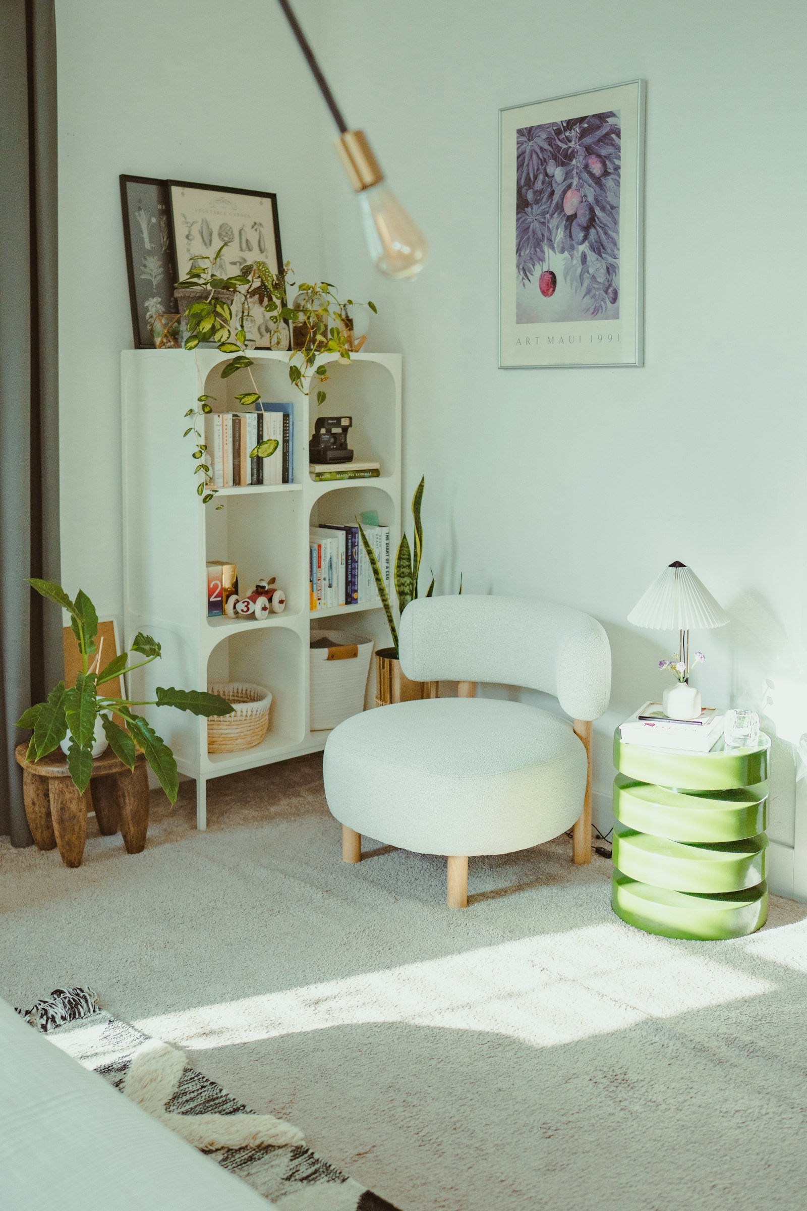 Reading nook with an armchair and plants, a cozy bedroom corner idea