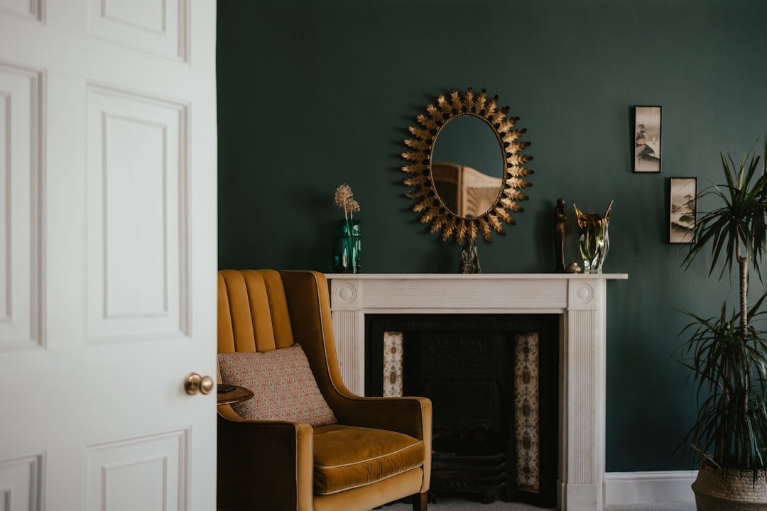 Deep moody autumn color palette in a dark living room with a fireplace