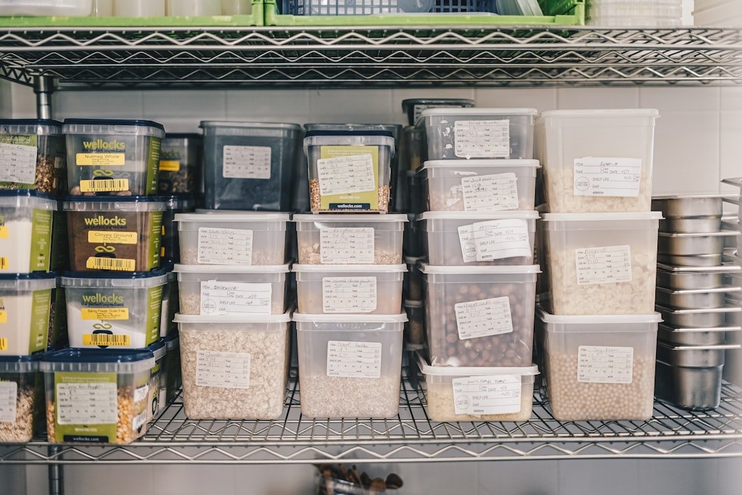 Pantry organization using stacked containers to use the vertical space on a deep shelf