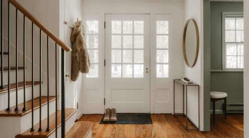 Bright foyer showing entryway storage ideas with a bench, hooks and a place for shoes
