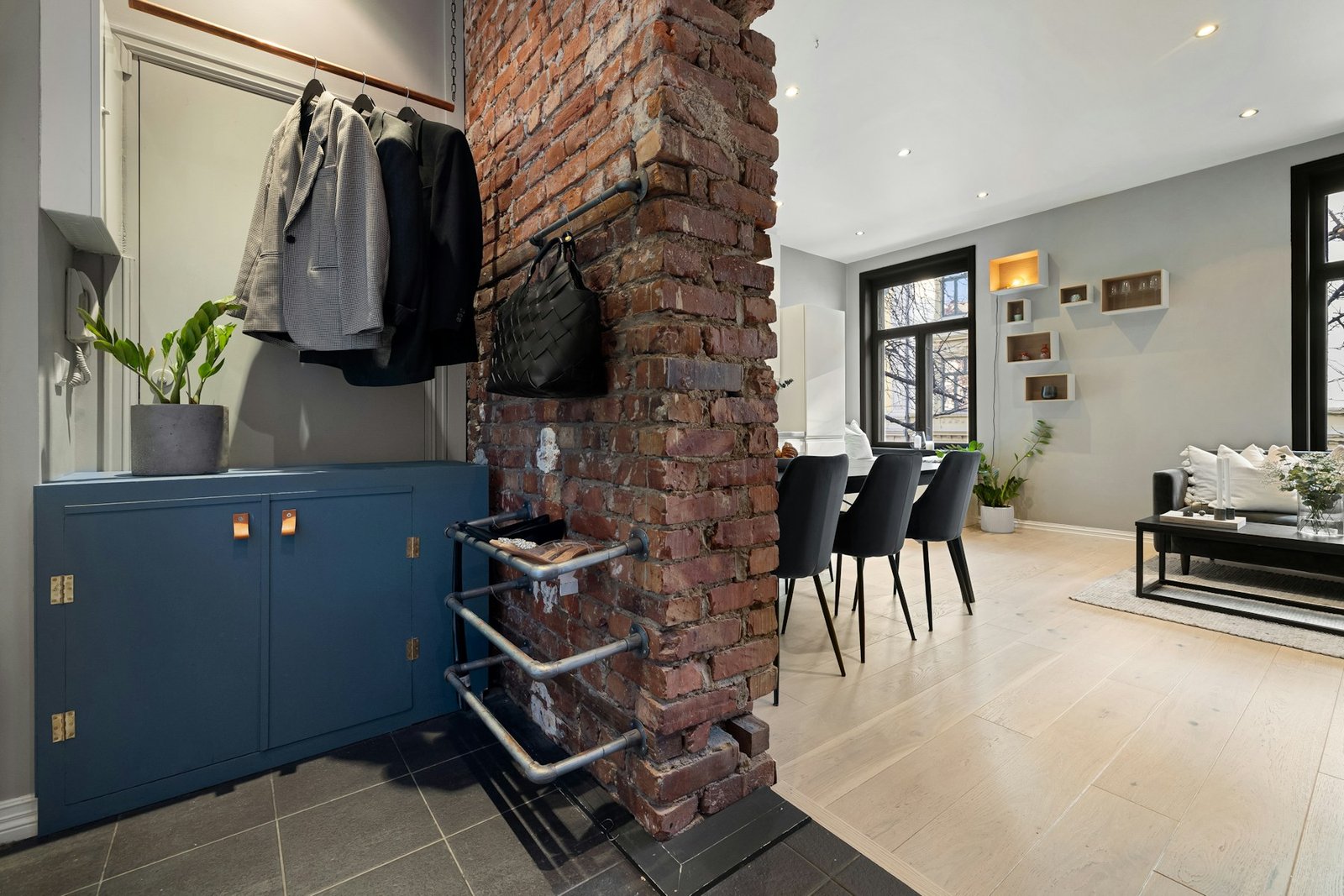 Open-plan interior with an exposed brick wall adding warm architectural texture