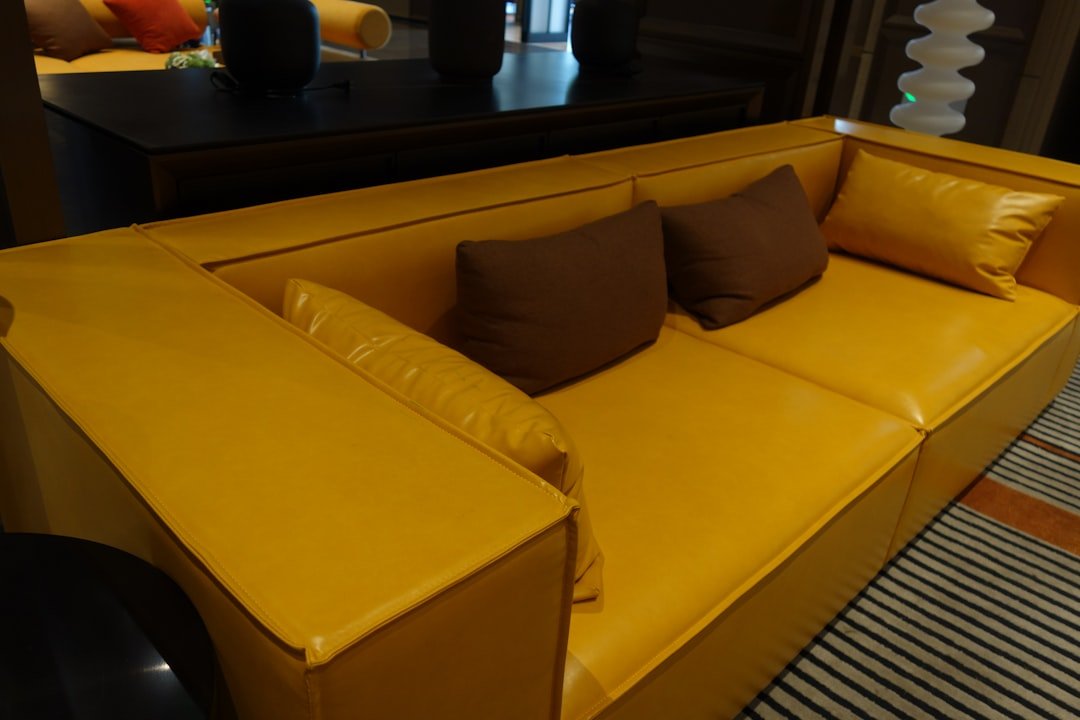 Gold and mustard autumn color palette with a yellow sofa and brown pillows