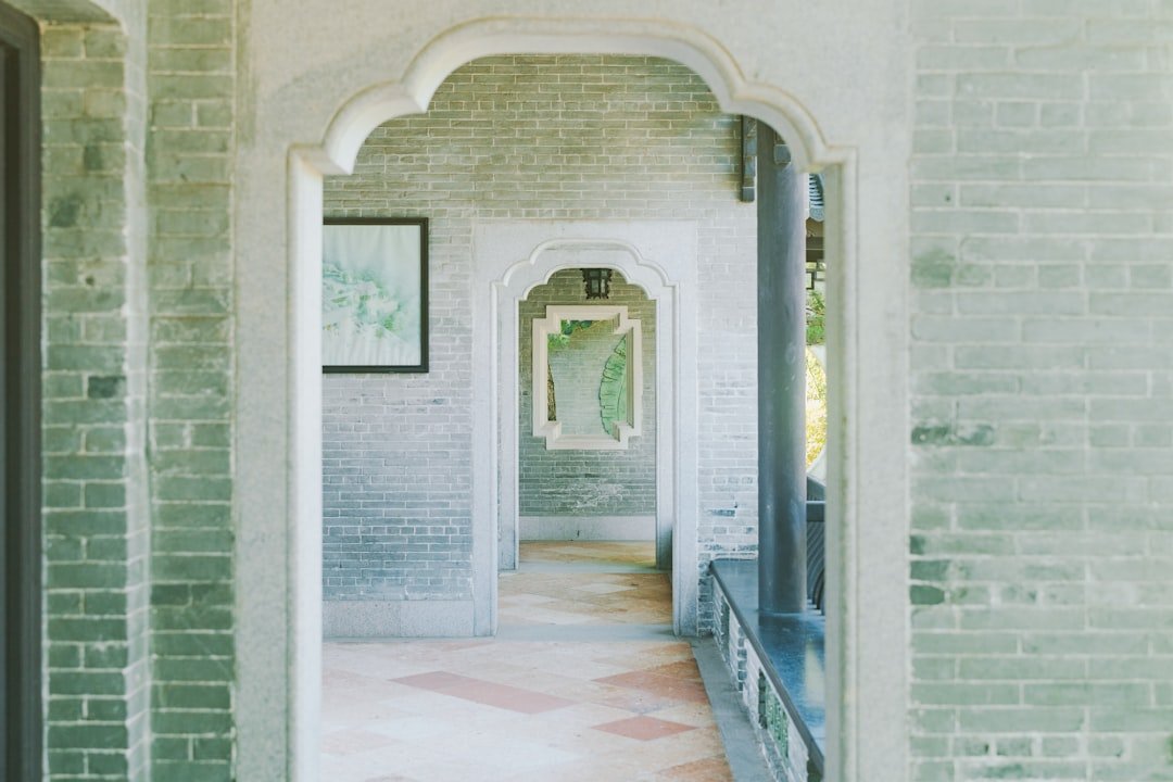 Entryway hallway painted deep green with artwork, showing color choices for entry storage areas