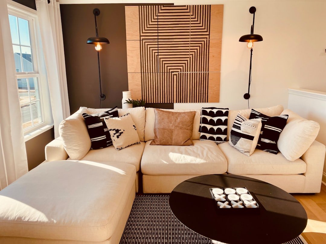 Warm modern living room with layered lighting, sofa, coffee table and multiple light sources
