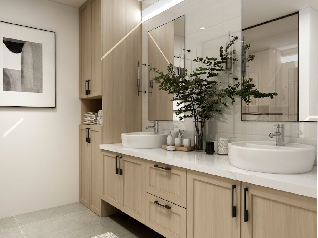Modern bathroom painted in a soft warm neutral with a white sink and simple fixtures