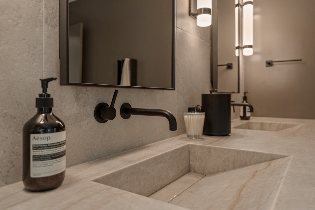 Modern bathroom tile ideas with natural stone walls and warm wood cabinetry