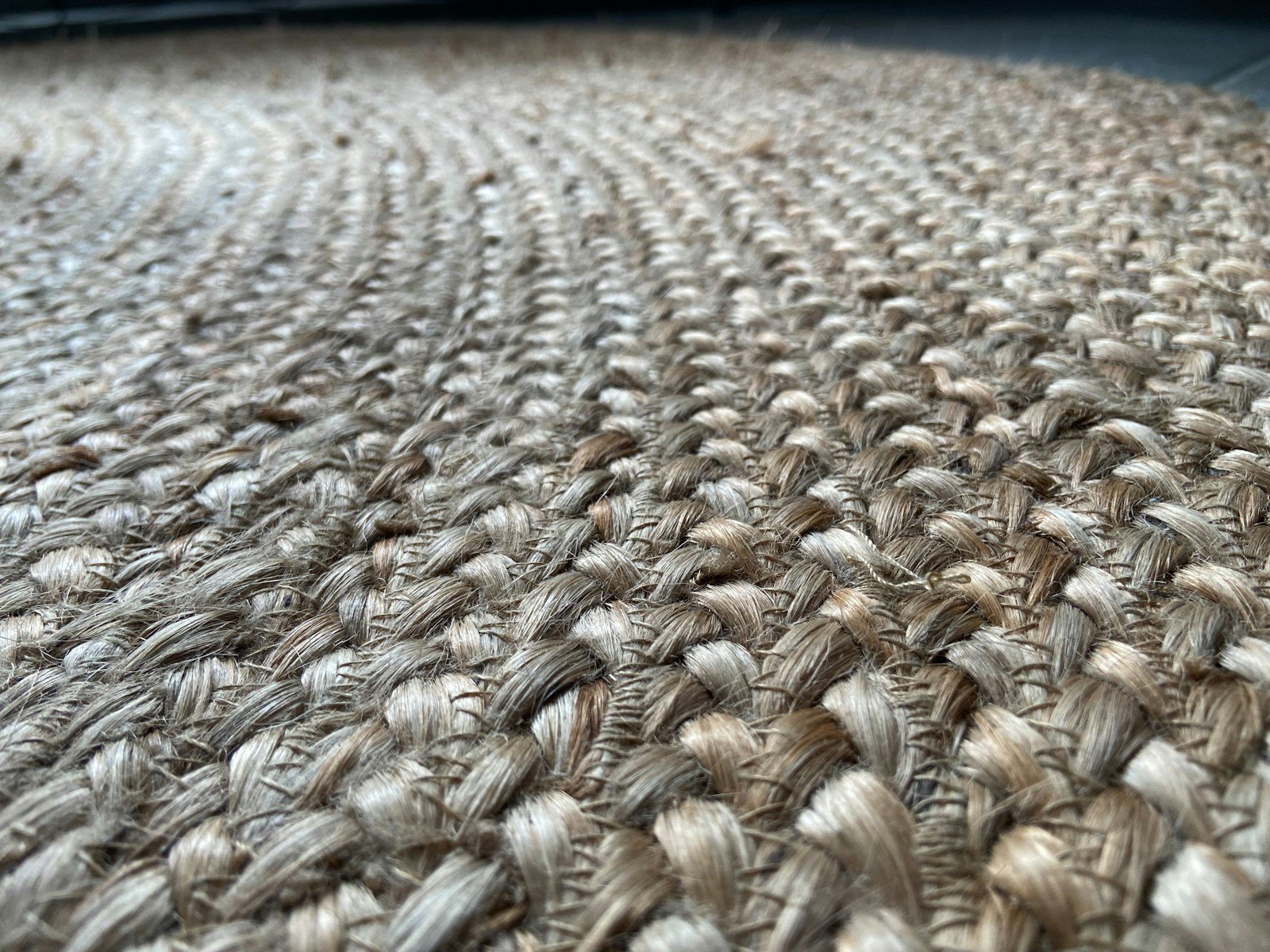 Close up of a natural jute rug, the woven texture that keeps beige interiors from looking flat