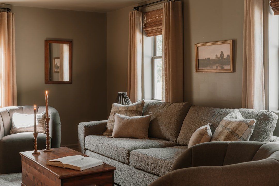 Neutral brown living room with layered upholstery, wood, and soft natural light