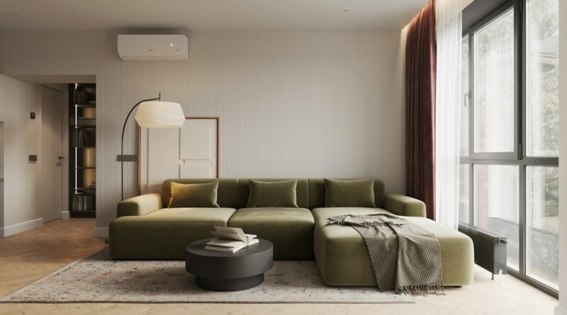Living room with an olive green sofa, warm white walls and wood accents showing olive green decor ideas