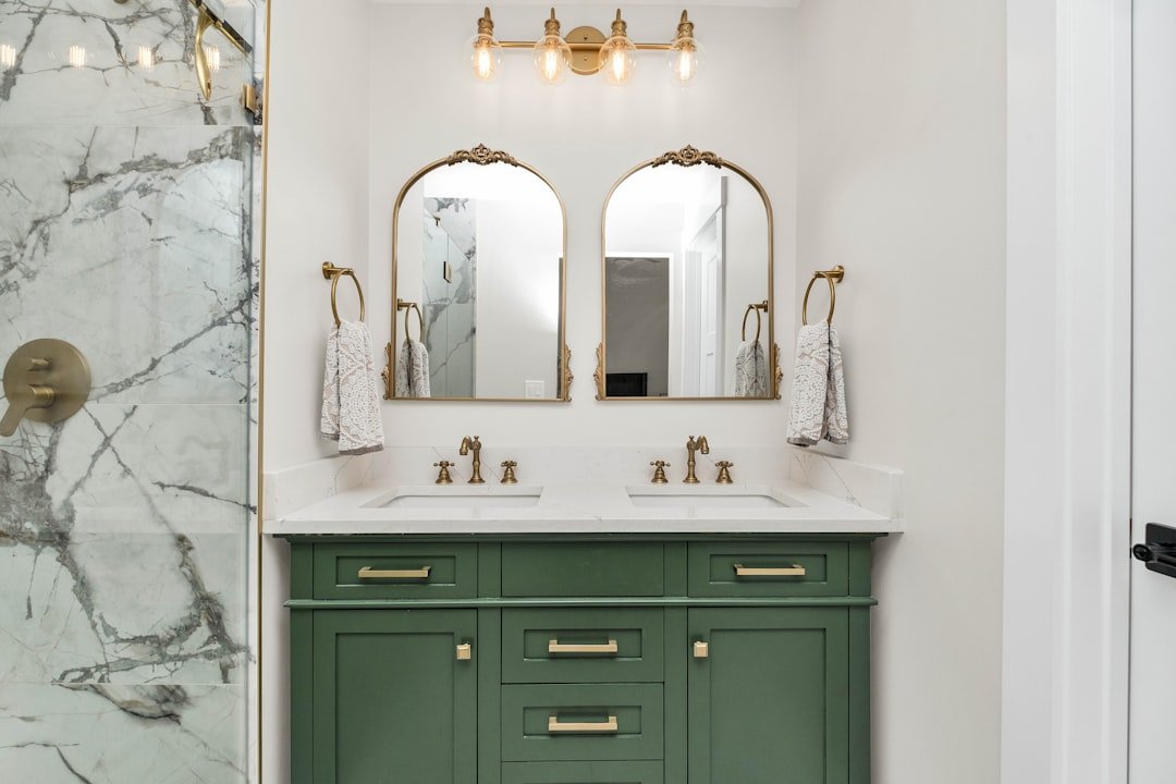 Bathroom with sage green vanity cabinets and marble countertop, sage green bathroom ideas
