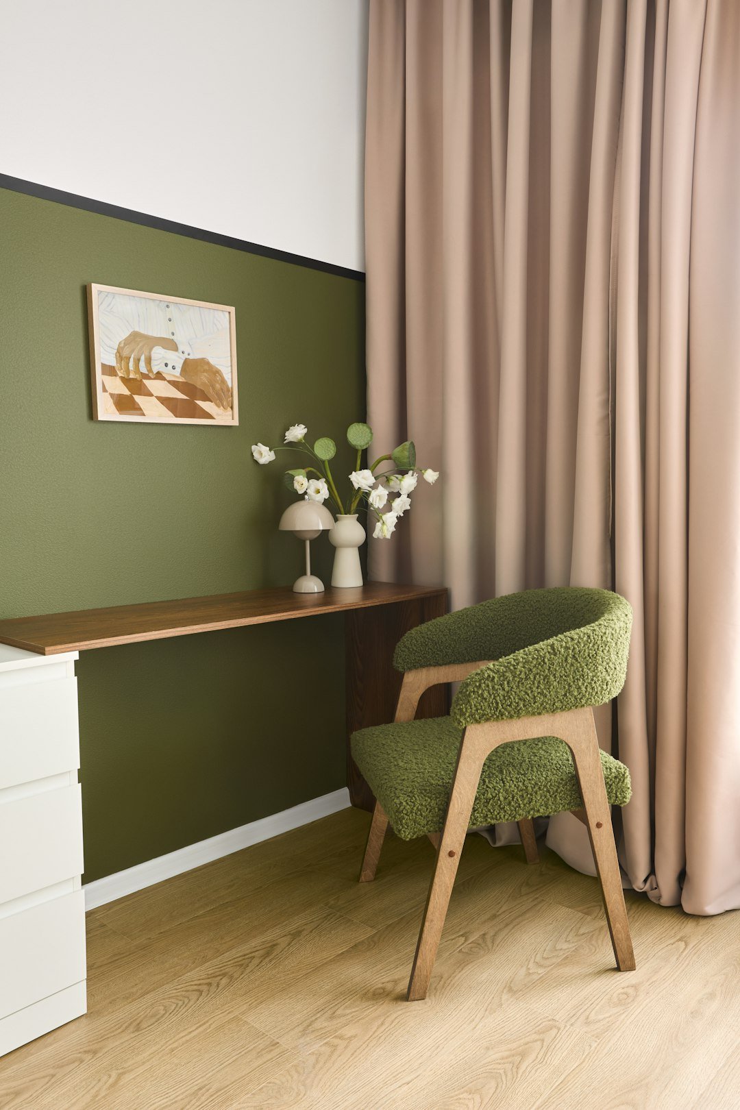 Home office with a sage green chair, desk and framed artwork, sage green office ideas