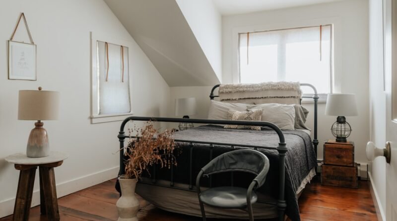 Small bedroom with light neutral walls, a low bed and warm bedding, an example of small bedroom ideas that feel calm