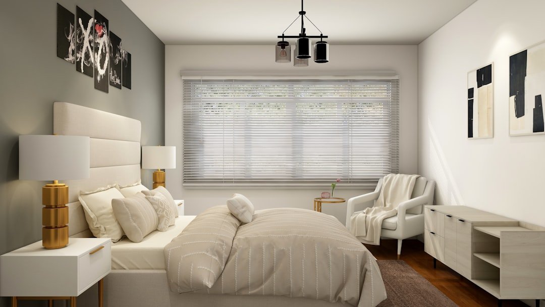 Bed placed under a window in a small bedroom layout with clear floor space on both sides