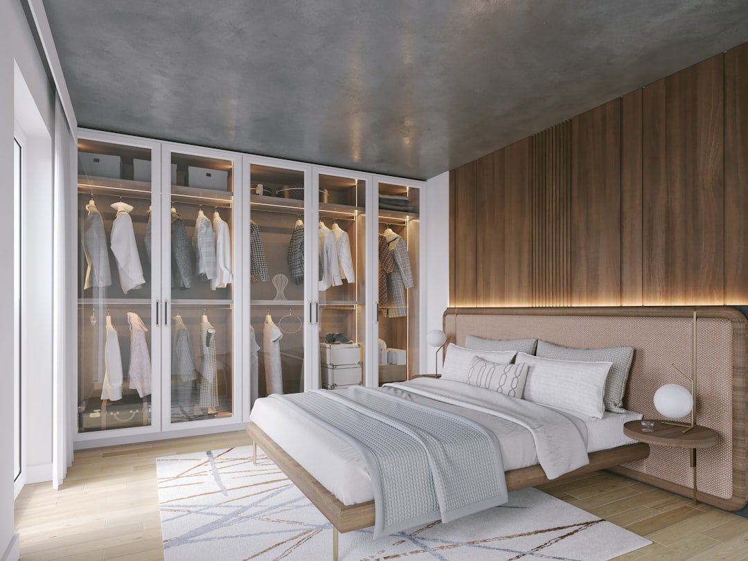 Small bedroom with a tall built-in wardrobe beside the bed, showing hidden storage ideas for tiny rooms