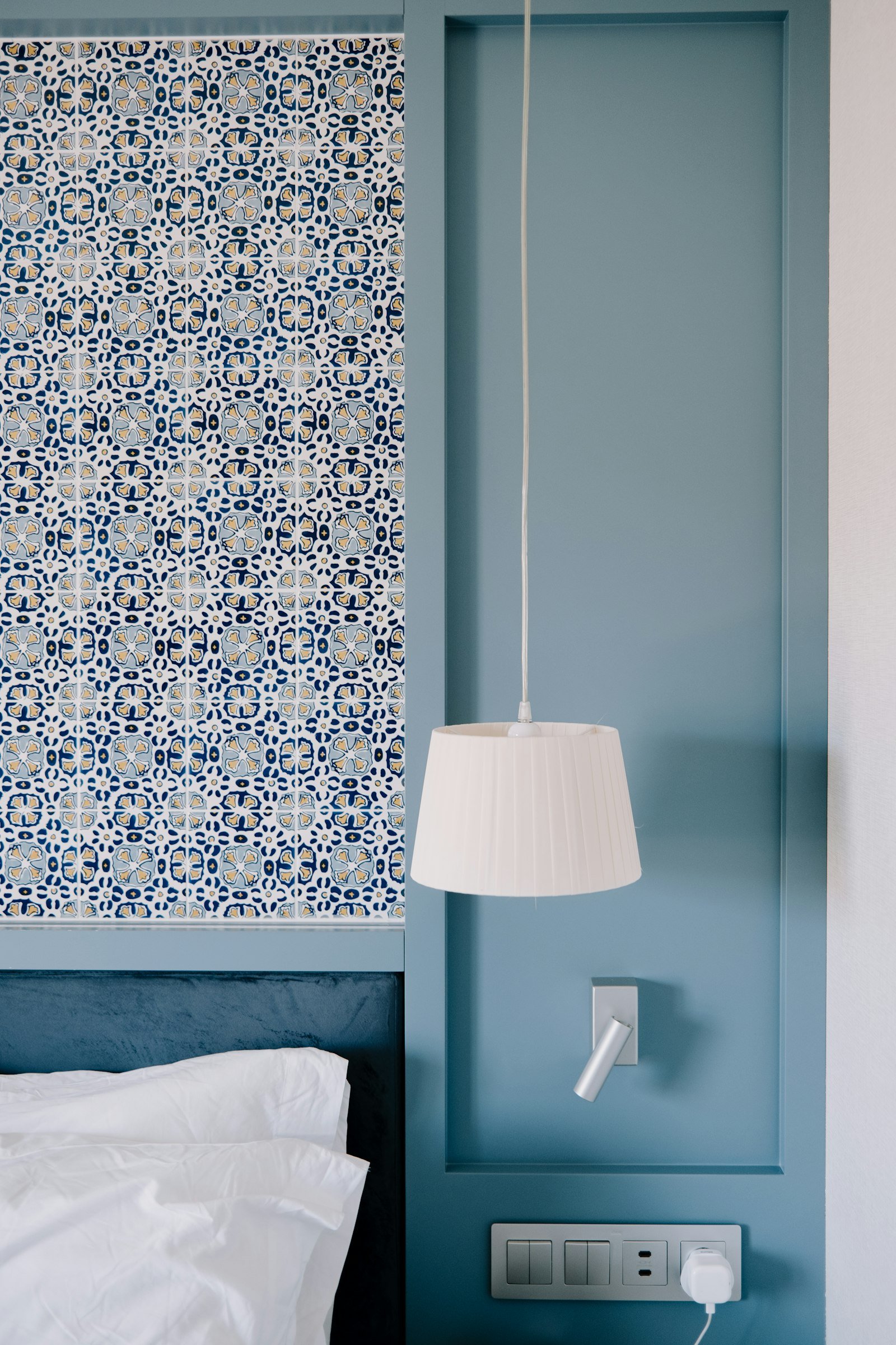 Soft blue bedroom idea with a pale blue wall and crisp white bedding