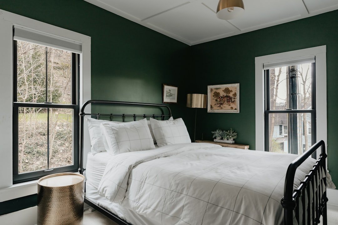 Soft green bedroom with calming sage tones and natural light