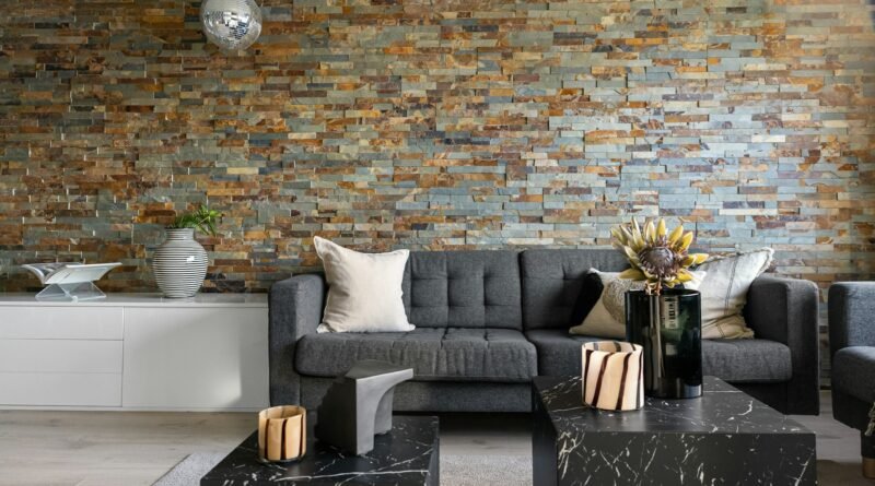 Warm living room with a textured stone wall, wood furniture and layered neutral decor