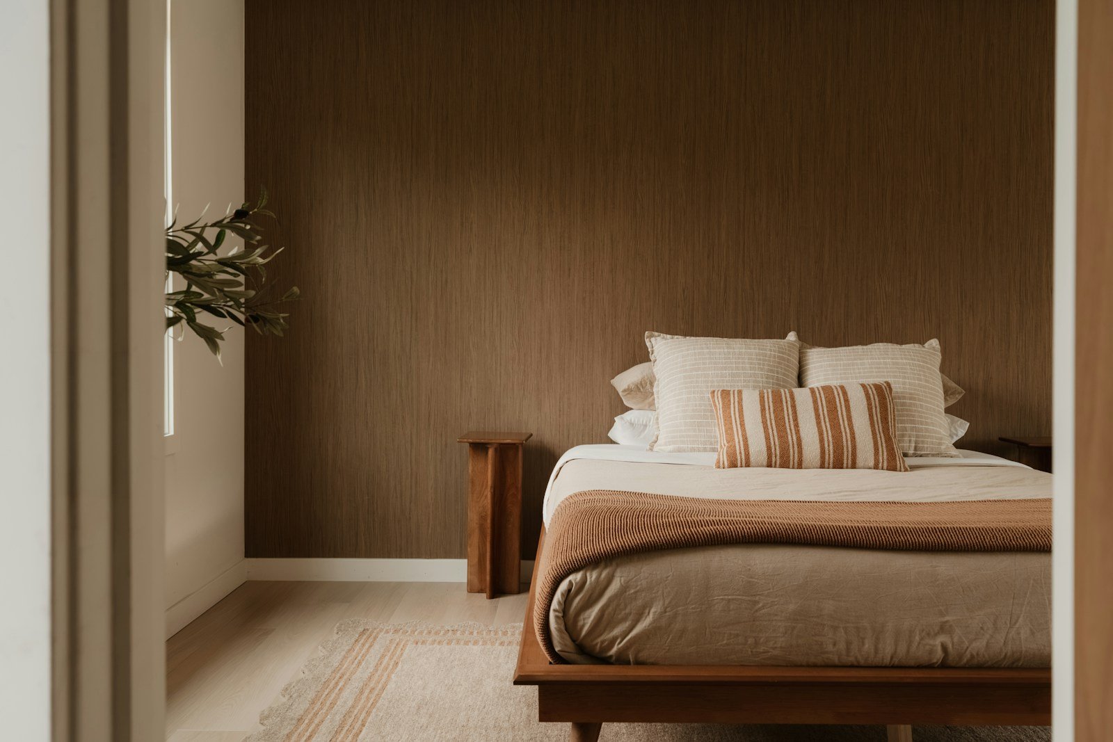 Warm brown bedroom walls with wood furniture, a warm take on dark bedroom colors