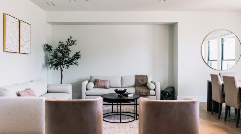 Warm neutral living room with beige sofas, earth tones and light wood floors