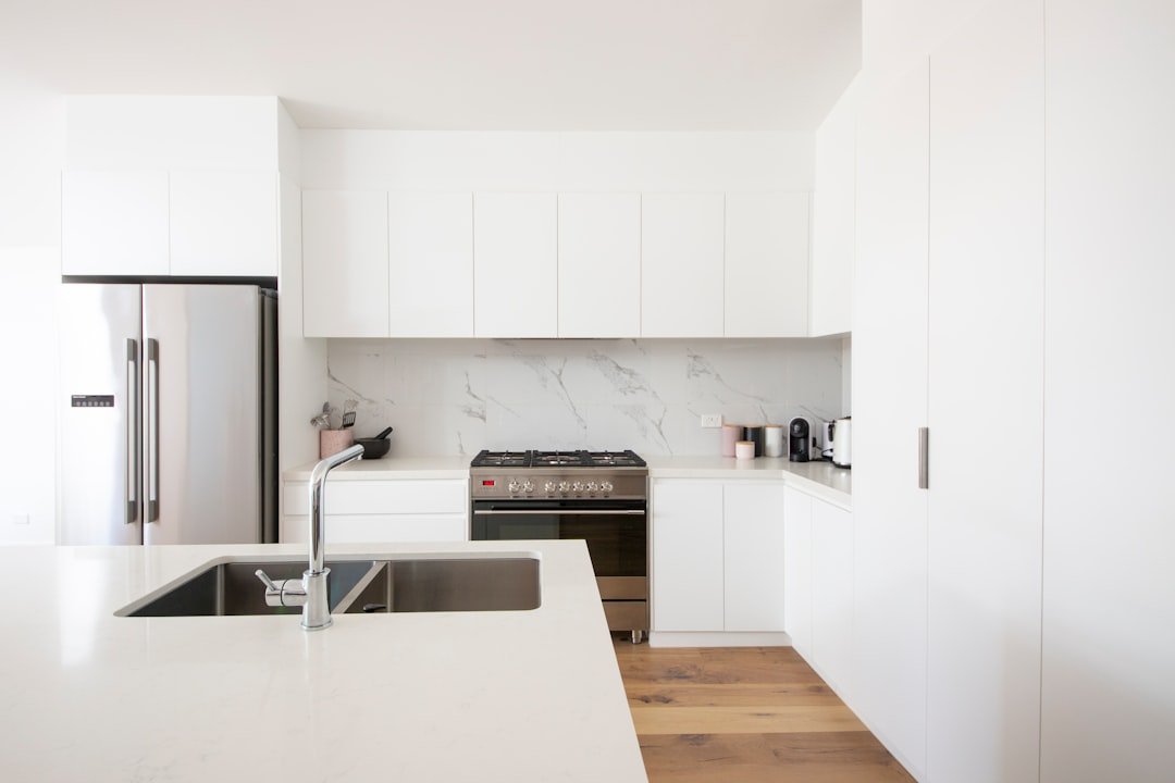Warm off-white kitchen cabinets in soft natural light, showing how a warm white paint reads in a real kitchen