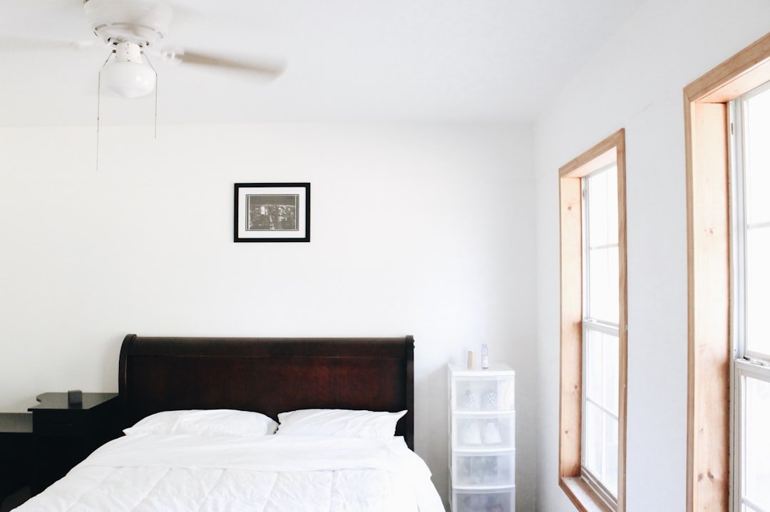 Small bedroom painted a warm white, showing how light paint colors make a small bedroom feel bigger