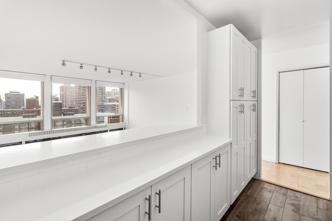 White built in cabinets used as entryway storage lockers with closed doors
