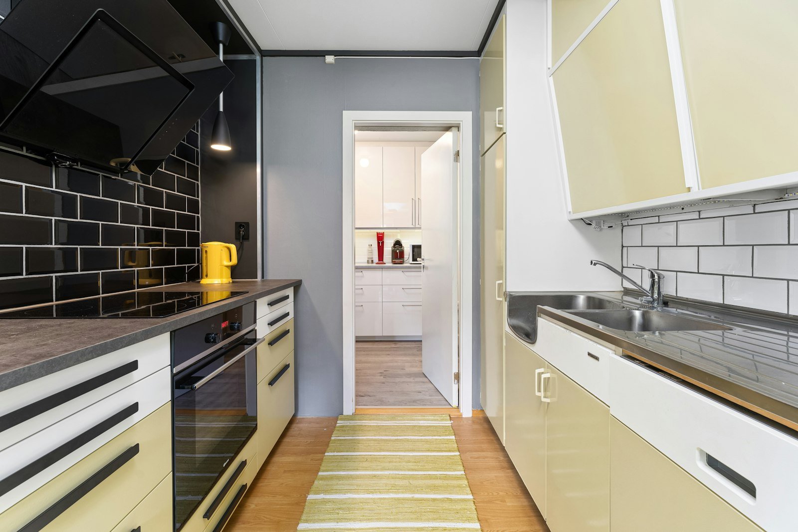 Warm yellow kitchen cabinet ideas in a narrow galley kitchen