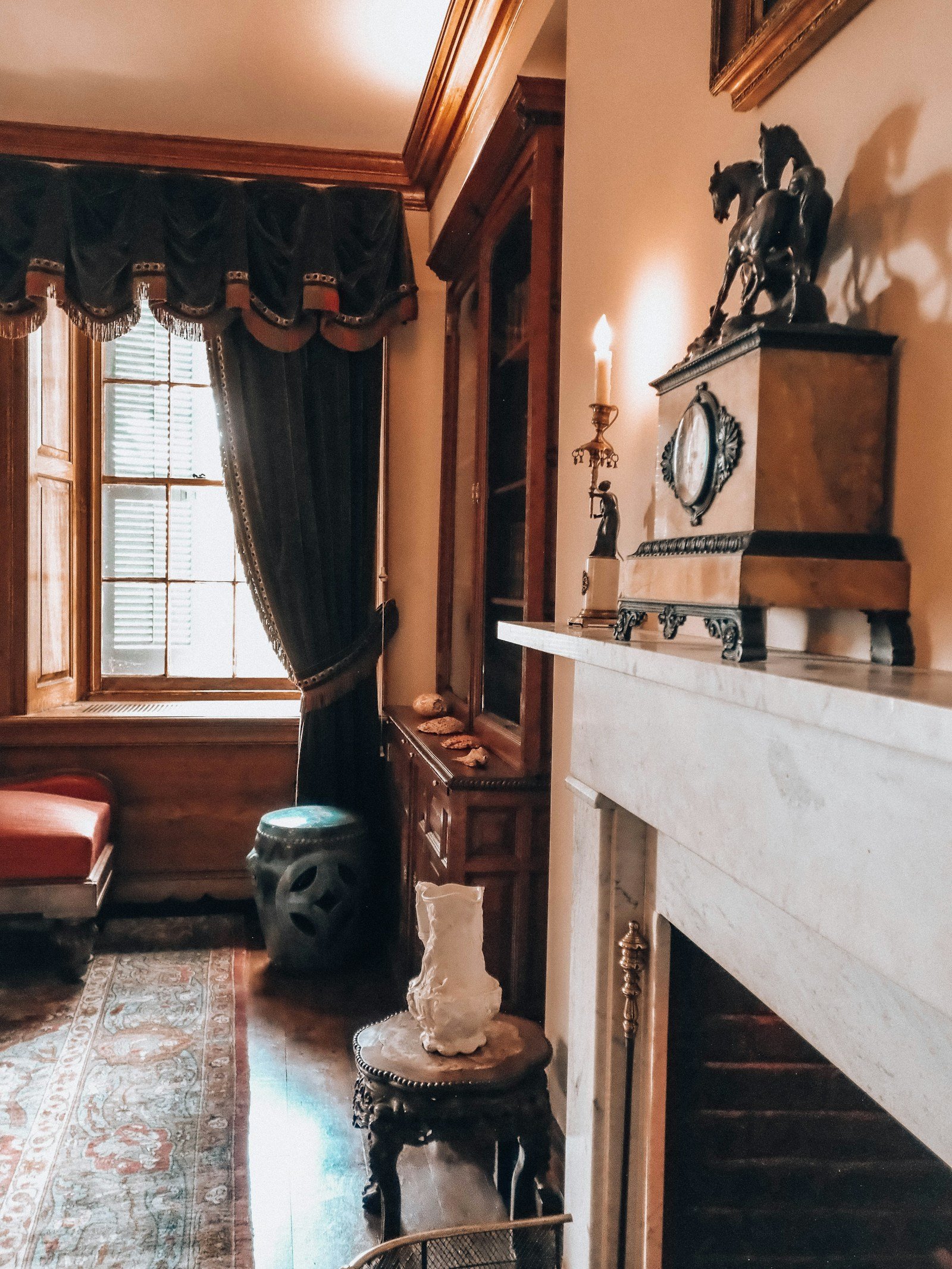 Classic room with a fireplace mantel, artwork and collected decorative objects