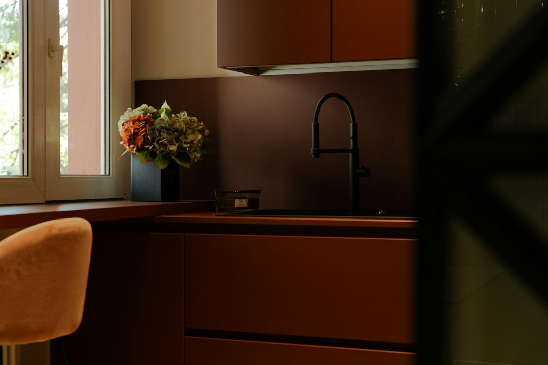 Kitchen with terracotta tile, warm wood finishes and soft natural light