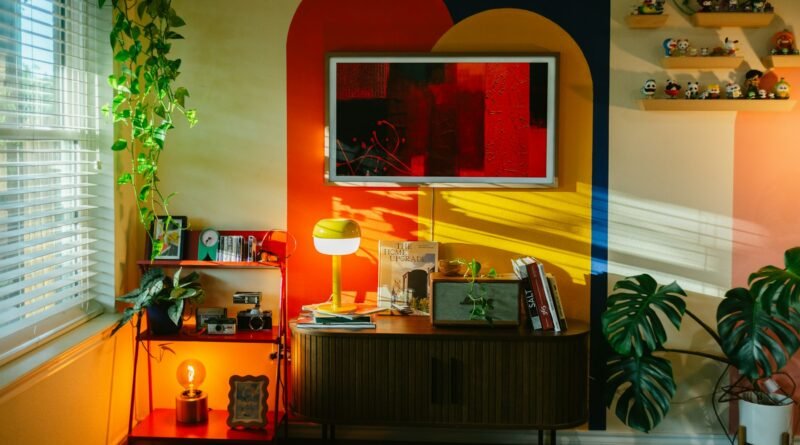 Colorful living room with geometric wall pattern, layered furnishings, books and houseplants