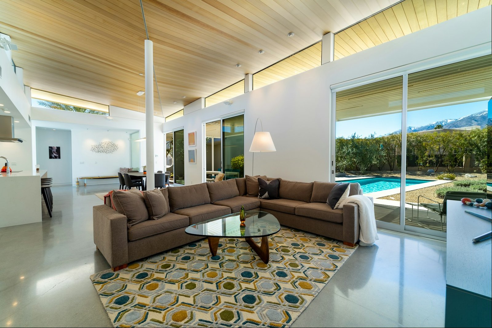 Bright living room with a large patterned area rug, sofa and coffee table