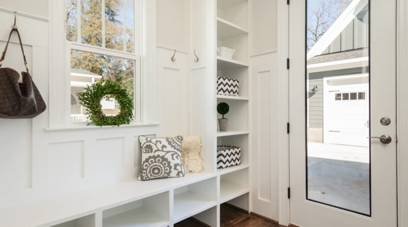 Mudroom with built-in cabinetry, bench seating, hooks and durable flooring
