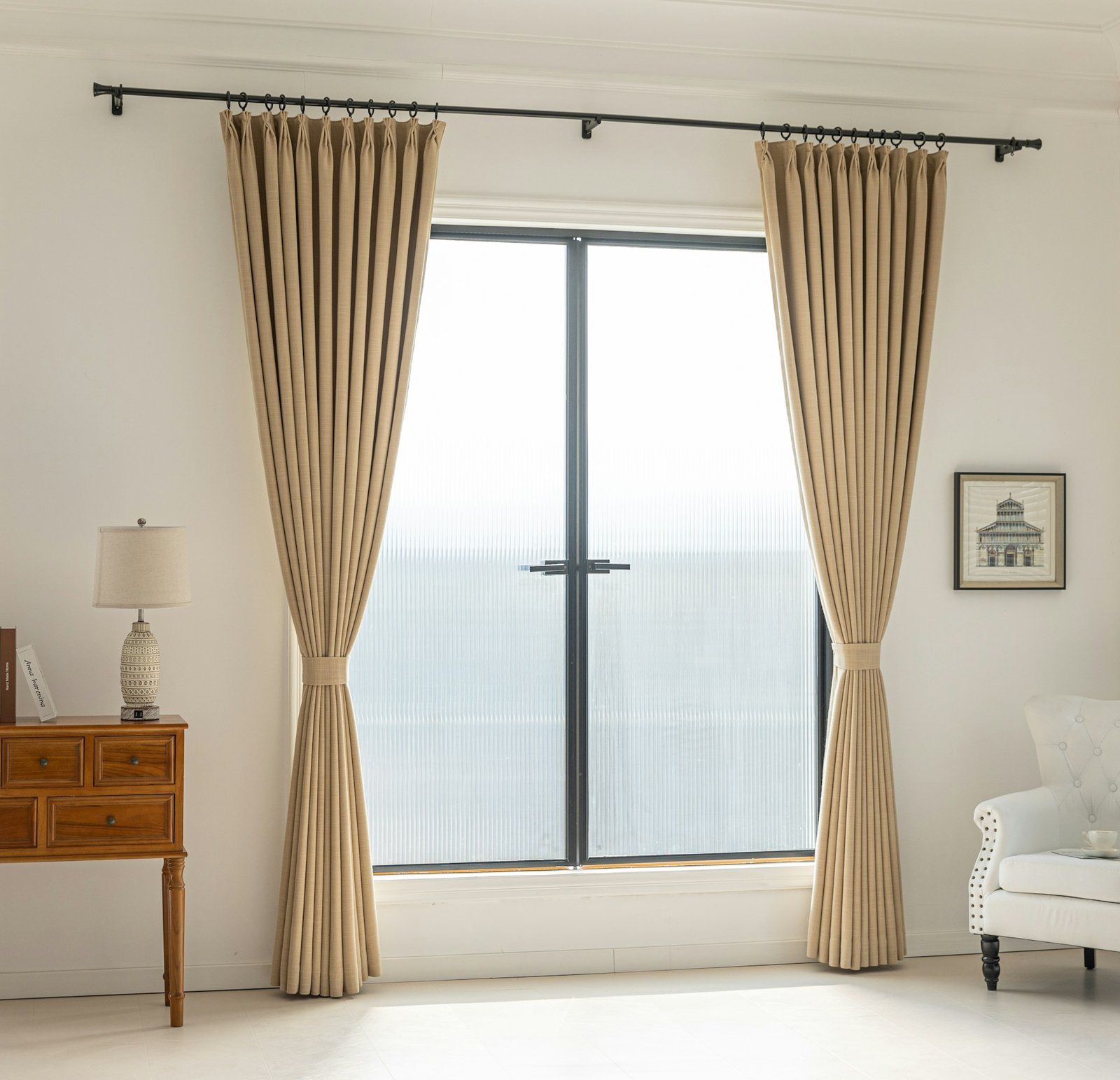 Bedroom window framed by full-length linen curtains filtering soft morning light