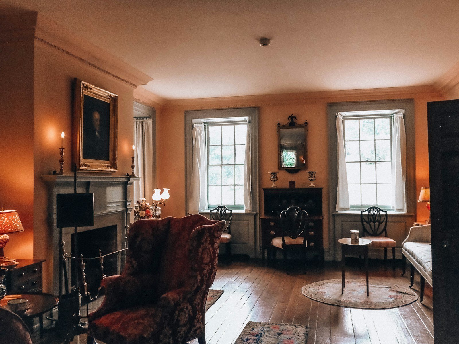 Traditional living room with an ornate fireplace mantel and warm layered decor