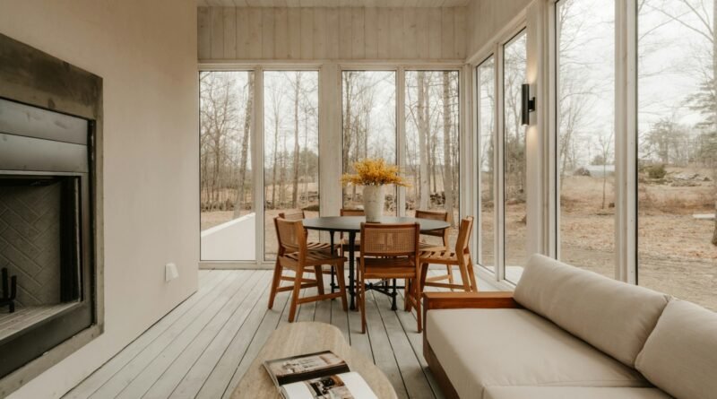 Warm modern living room with a stone fireplace, mantel and layered seating